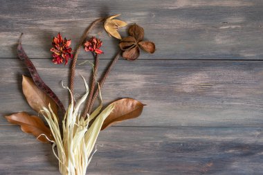 Ahşap arka planda kurumuş renkli çiçekler. Uzayı kopyala Romantik çiçekler. Metin ve tasarım için yer. Tebrik kartı. Düz yatış, üst görünüm.