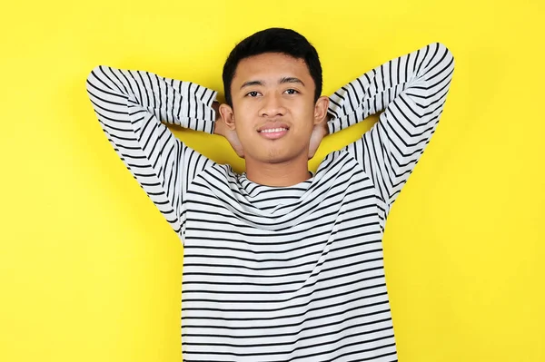 Portrait of young Asian man on a yellow — Stock Photo, Image