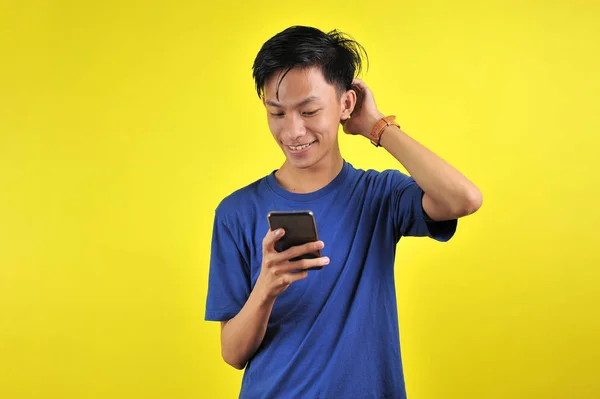 Happy of young good looking Asian man smiling using smartphone — 스톡 사진