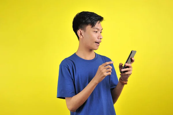 Happy of young good looking Asian man smiling using smartphone — 스톡 사진