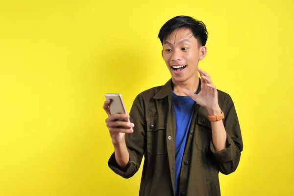 Happy of young good looking Asian man smiling using smartphone — 스톡 사진