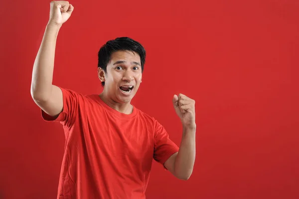 Young asian man happy and excited expressing winning gesture. — Stock Photo, Image