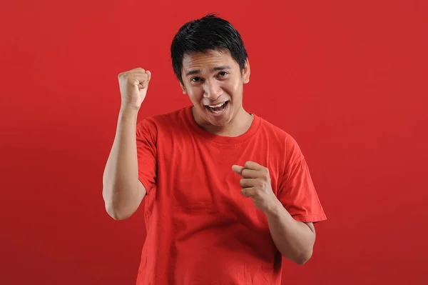 Young asian man happy and excited expressing winning gesture. — Stock Photo, Image