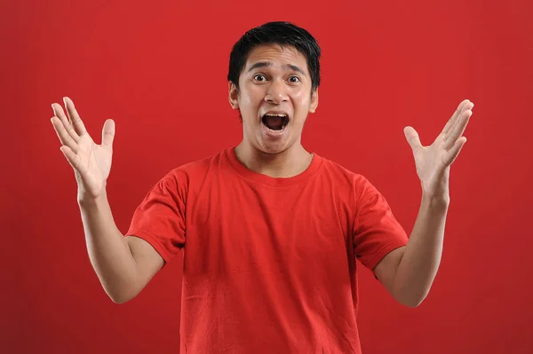 Young asian man happy and excited expressing winning gesture. — Stock Photo, Image