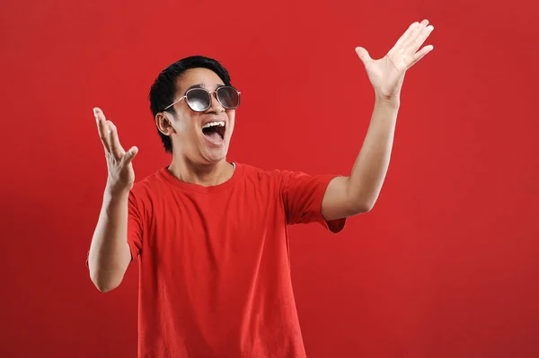 Young asian man happy and excited expressing winning gesture. — Stock Photo, Image