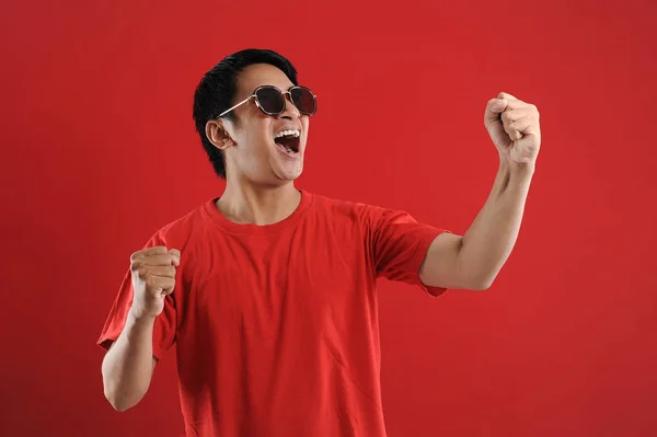 Young asian man happy and excited expressing winning gesture. — Stock Photo, Image