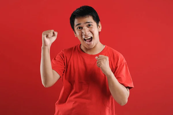 Young asian man happy and excited expressing winning gesture. — Stock Photo, Image