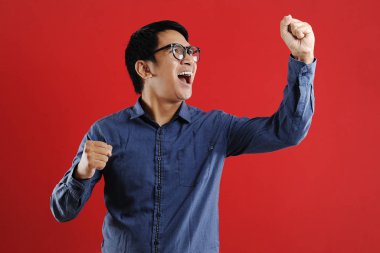 Asyalı genç adam mutlu ve heyecanlı Kazanan jestler.