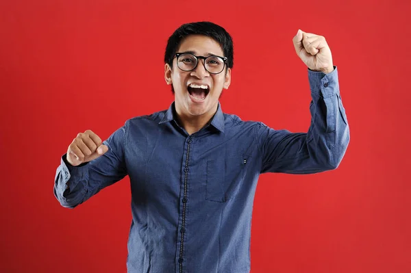 Young asian man happy and excited expressing winning gesture. — 스톡 사진