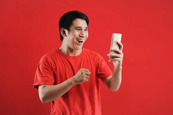 Mutlu Asyalı adam cep telefonunda yeni metin okuyor