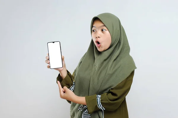 Portret Podekscytowanej Muzułmanki Trzymającej Telefon Pustym Ekranem Odizolowanej Szaro — Zdjęcie stockowe