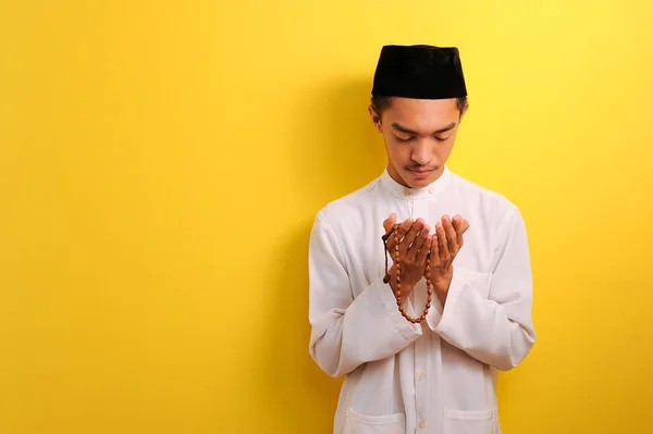 Młody Muzułmanin Azjatycki Modli Się Podnosząc Rękę Trzymając Paciorki Modlitewne — Zdjęcie stockowe