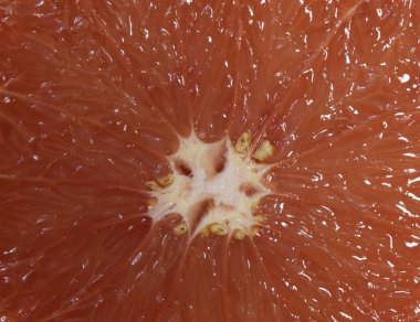 Greyfurt dilimi dokusu, yakın plan, narenciye. Kırmızı greyfurt makrosu. Taze greyfurt desenli arka plan, makro. Sağlıklı yiyecekler. Seçici odak.