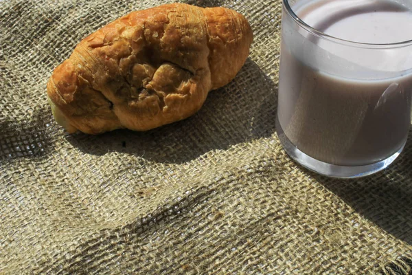 Croissant and yogurt on a piece of cloth