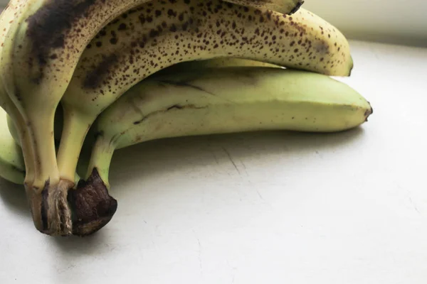 Old bananas on a stone table