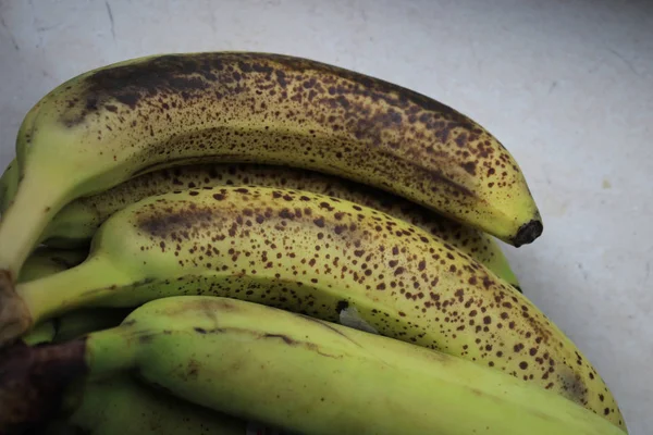 Old bananas on a stone table