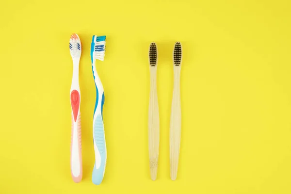 Two Types Toothbrushes Plastic Bamboo Natural Toothbrushes Yellow Background Choice — Stock Photo, Image