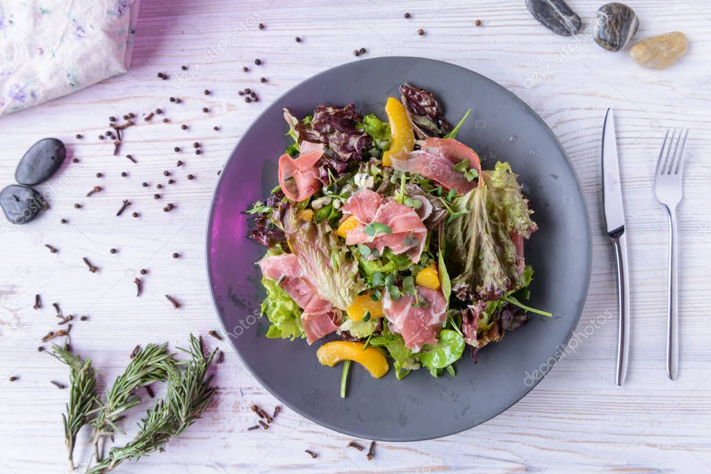 fresh salad in beautiful composition on a concrete background