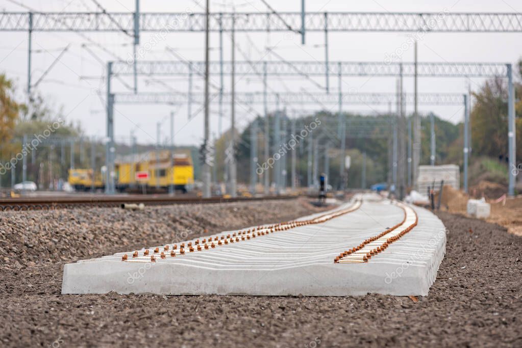 Modernization of the railway line in Poland. New track, crushed stone, railway sleepers, poles, trusses and energy infrastructure.