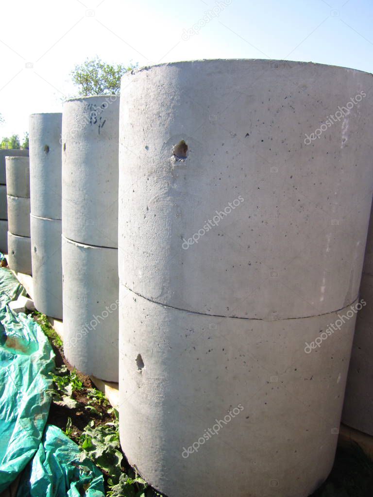 a stack of reinforced concrete rings for the installation of wells in the sewage system and water supply