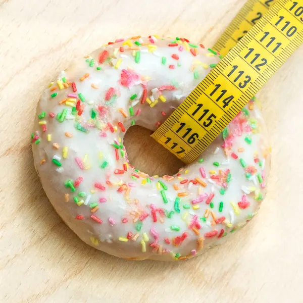 Measuring Tape Inserted Sweet Donut White Icing View Junk Food — Stock Photo, Image