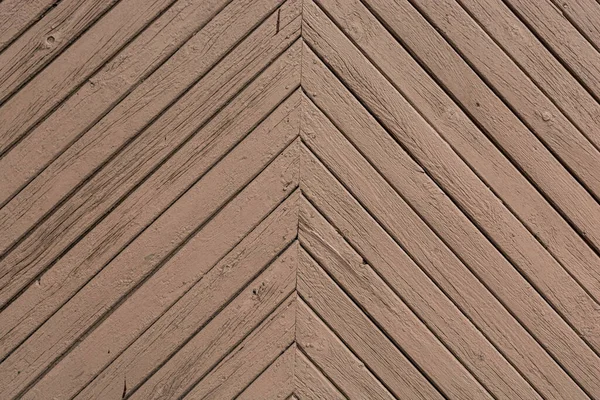 Old brown boards as a background. The boards are located diagonally and form a right angle.