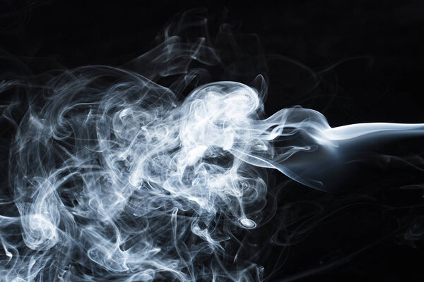 Photo of a wisp of smoke on a dark background