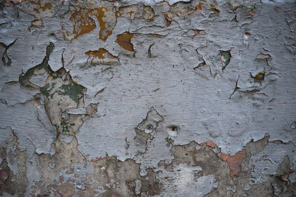 Textura de uma parede velha coberta de tinta. Imagem de fundo de um — Fotografia de Stock