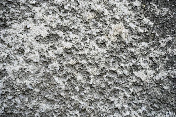 Konsistens av en gammal sprucken betongvägg. Bakgrundsbild av en w — Stockfoto