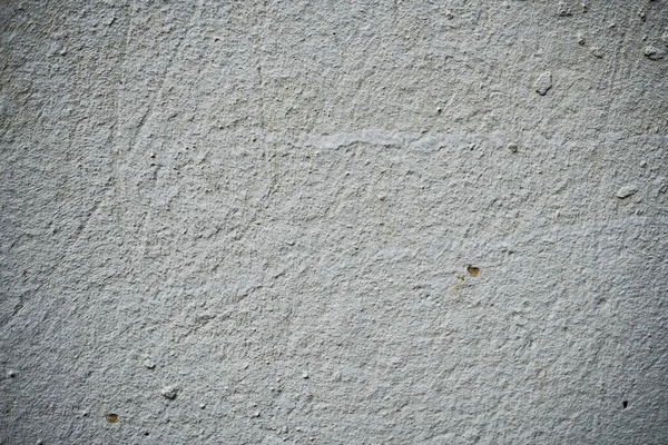 Textura de uma parede velha coberta de tinta. Imagem de fundo de um — Fotografia de Stock