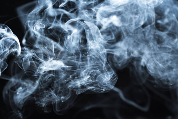 Photo of a wisp of smoke on a dark background