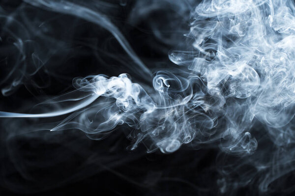 Photo of a wisp of smoke on a dark background