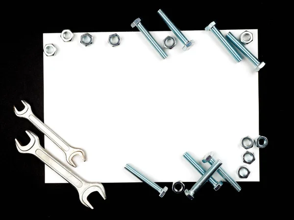 Text insertion frame lined with bolts, nuts and wrenches — Stock Photo, Image
