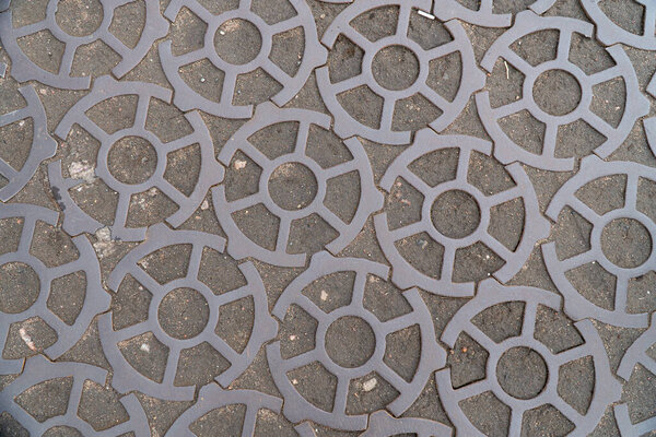 Background image of pavement surface. Wallpaper. Substrate for text. Detailed texture. Idea for exterior and interior. Geometric pattern. Metal gears.