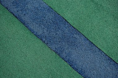 Yumuşak, şok geçirmez, kauçuk zemin yüzeyinin arka plan görüntüsü. Duvar kağıdı. Metin için substrat. Çocuk parkının kauçuk yüzeyinin detaylı dokusu. Dış ve iç mekan için fikir. Üst görünüm.