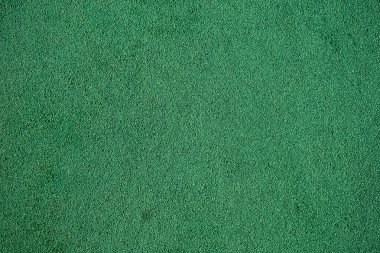 Yumuşak, şok geçirmez, kauçuk zemin yüzeyinin arka plan görüntüsü. Duvar kağıdı. Metin için substrat. Çocuk parkının kauçuk yüzeyinin detaylı dokusu. Dış ve iç mekan için fikir. Üst görünüm.