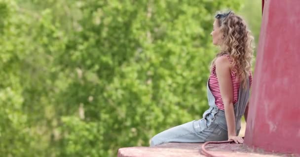 Girl Curly Hair Jumpsuit Sits Nature — Stock Video