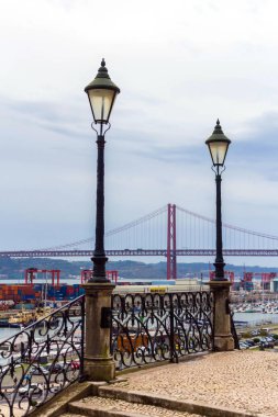 View of the 25 de Abril Bridge and port, Lisbon, Portugal. November 30, 2016 clipart