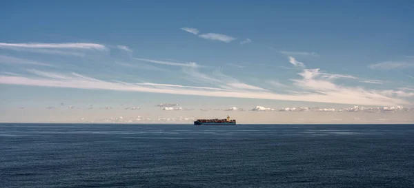 Container ship at sea. Wide banner, Bright summer sunny day, sea, blue water. Shipping cargo by sea. Logistic.