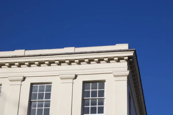 Traditional white building against deep blue sky — 스톡 사진
