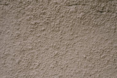 Gri kahverengi alçı duvar. Boşluk kopyalamak için saç kurutma makinesi yapılıyor