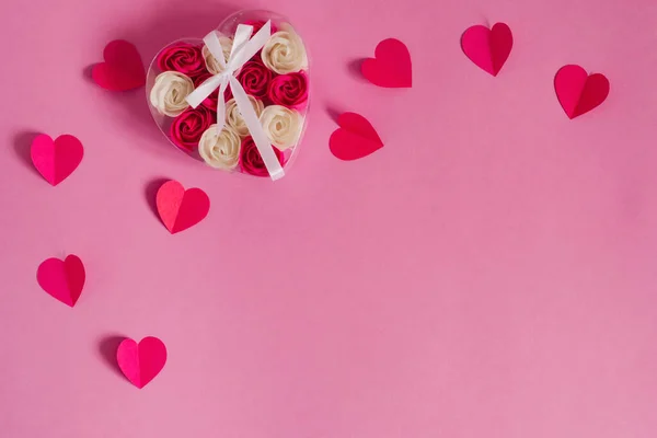 Raspberry pink paper hearts and a heart of rose buds on a pink b — Stock Photo, Image