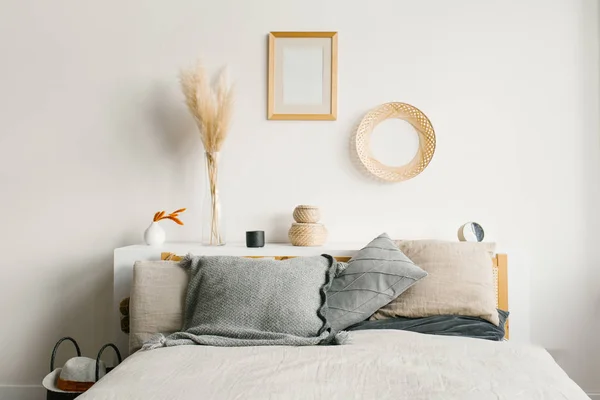 Bed in the bedroom in a Scandinavian minimalist natural style. G