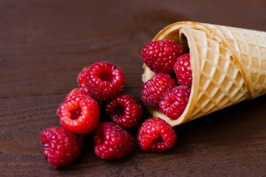 Waffle cone with fresh organic raspberries 