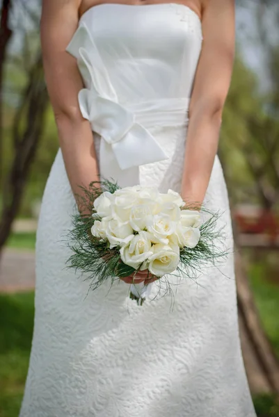 Delicate beautiful wedding bouquet of white roses and greenery i