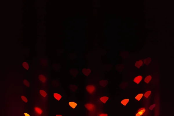 Abstract blur defocused background black, red-orange lights glar — Stockfoto