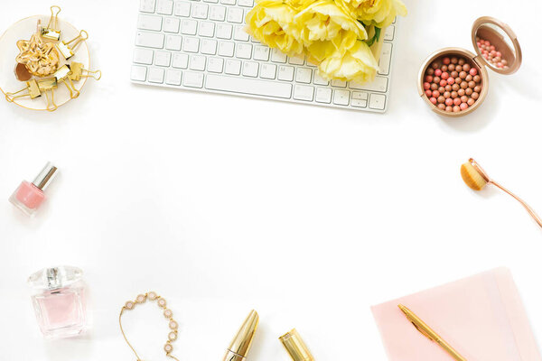 Workplace of a fashion blogger with a bouquet of yellow spring tulips. Stylish Flat lay with copy space