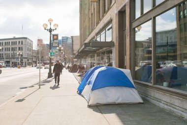 Seattle, Washington, USA. March 2020. Homeless tents on a city street, in downtown clipart