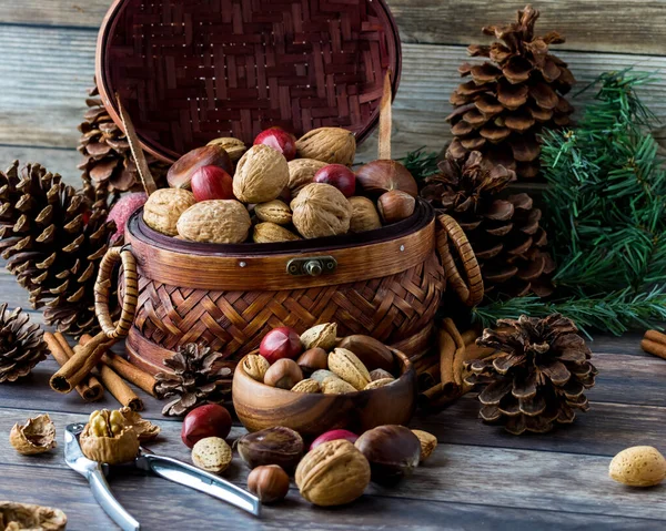 Heaping basket of mixed nuts and pinecones.