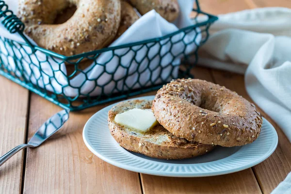 Multi grain bagel and butter. — Stock Photo, Image